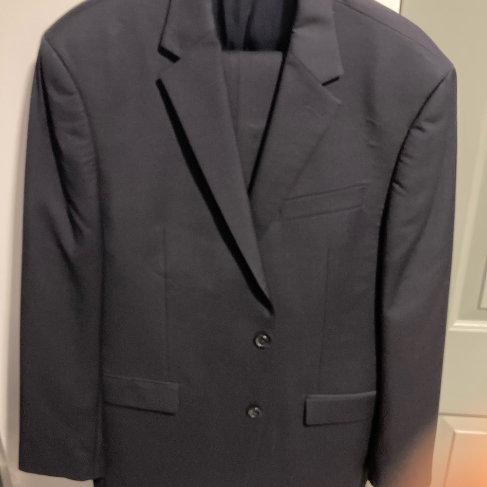 Mens navy blue classic Calvin Klein suit. Timeless style.